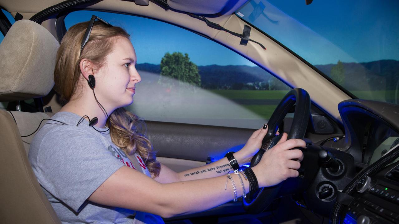 female blond student participating in the drive simulator